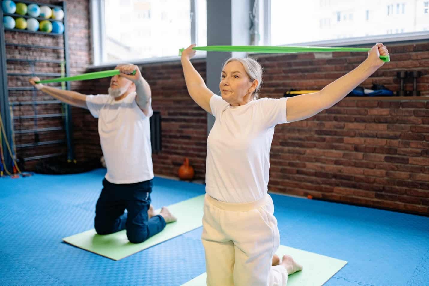 Couple Using Resistance Bands on Mats